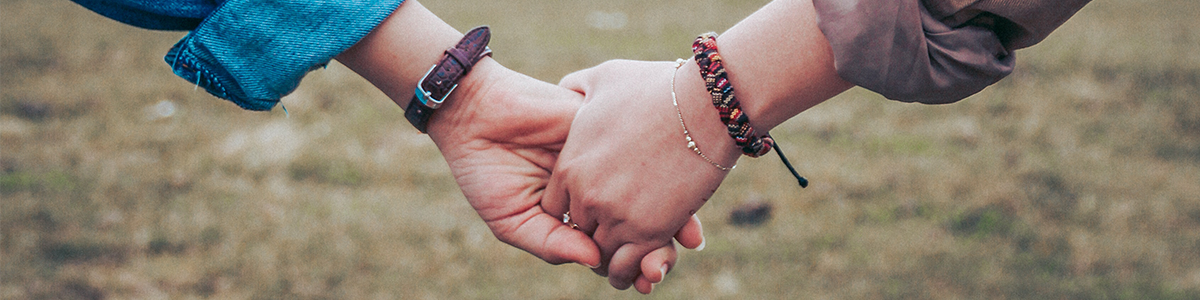 A photo showing two hands holding.