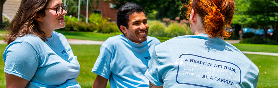 Three Well-Being student Activators wearing bule shirts.