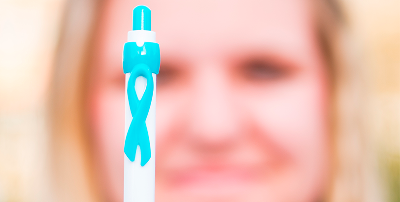A blurred face of  woman holding a pen with the VOICE ribbon logo.